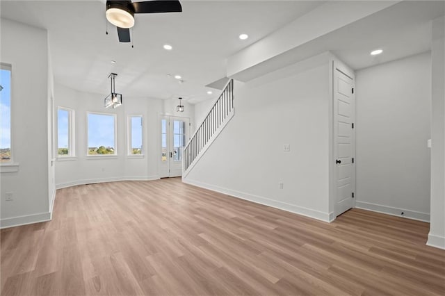 unfurnished living room featuring light hardwood / wood-style floors and ceiling fan