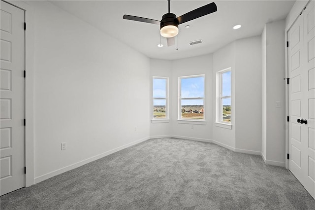 unfurnished bedroom featuring ceiling fan and light colored carpet