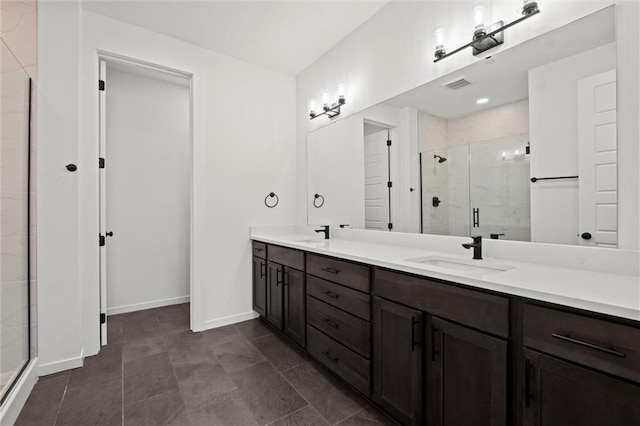 bathroom featuring tile patterned flooring, an enclosed shower, and vanity