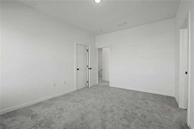 unfurnished bedroom featuring light carpet