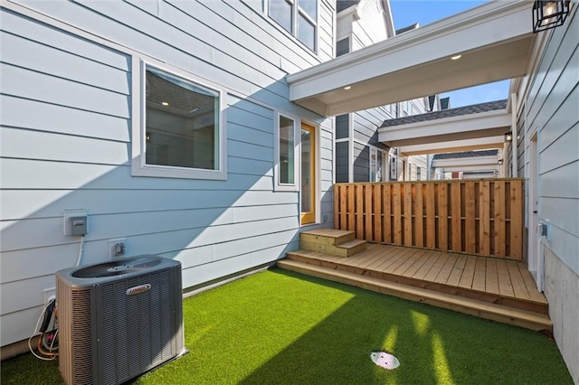 view of yard with central AC unit and a wooden deck