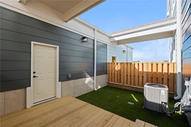 view of yard featuring a deck and central AC