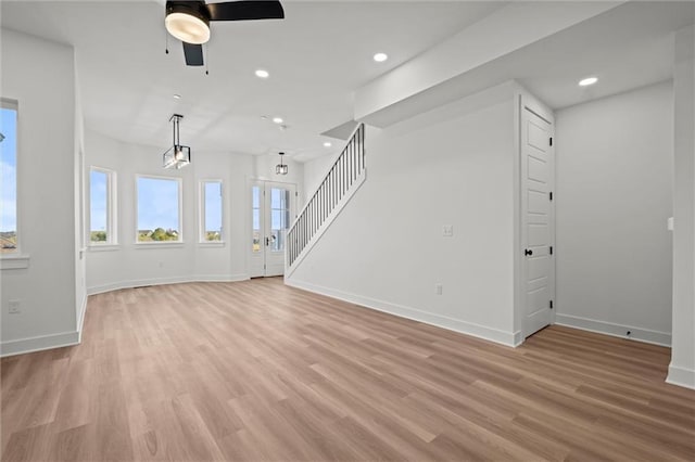 454 SW Brummel Rd, Lees Summit, MO 64081 - unfurnished living room featuring a ceiling fan, baseboards, light wood-type flooring, stairs, and recessed lighting