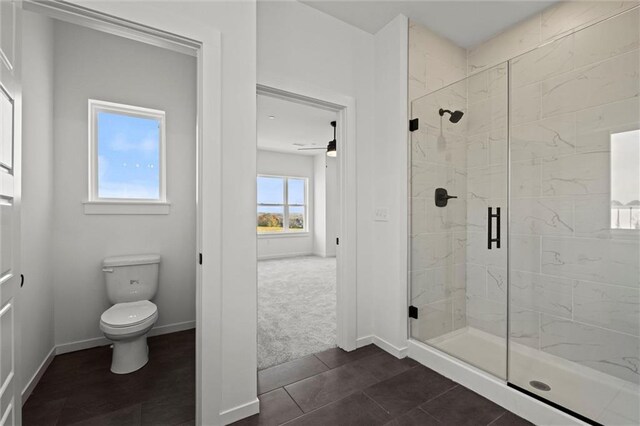 458 SW Brummel Rd, Lees Summit, MO 64081 - bathroom featuring a marble finish shower, toilet, baseboards, and tile patterned flooring