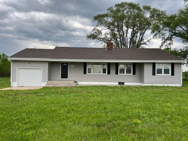 ranch-style home with a front lawn and a garage