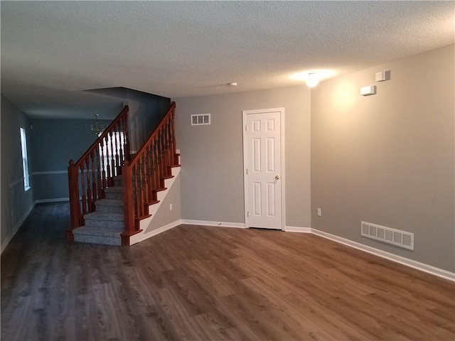 basement with stairs, wood finished floors, and visible vents