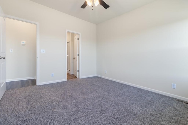 interior space featuring ceiling fan and dark carpet