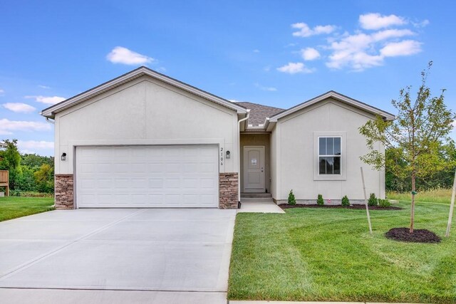 ranch-style home with a garage and a front yard