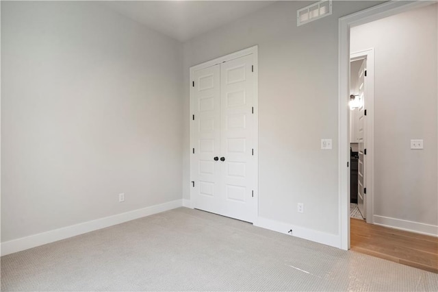 unfurnished bedroom featuring a closet and carpet floors