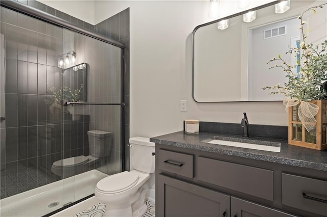 bathroom featuring oversized vanity, an enclosed shower, and toilet