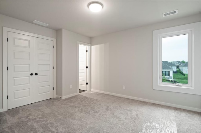 unfurnished bedroom featuring a closet and carpet floors