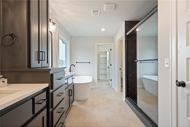 bathroom with tile flooring, oversized vanity, and plus walk in shower