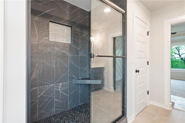 bathroom with walk in shower and tile floors