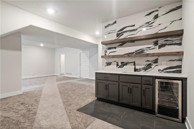 bar featuring wine cooler and dark tile floors