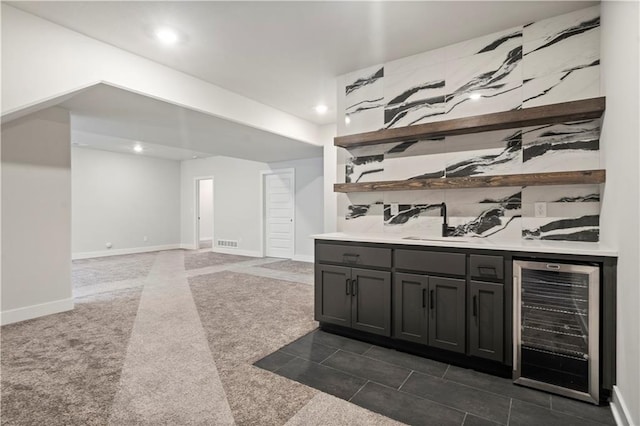 bar with wine cooler and dark tile floors