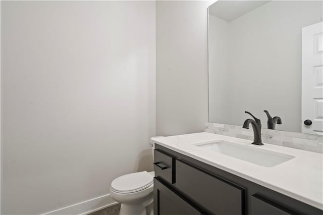 bathroom with toilet and vanity