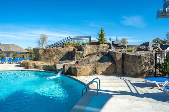 view of pool featuring pool water feature and a patio area