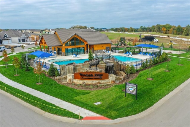 view of pool with a yard and a patio