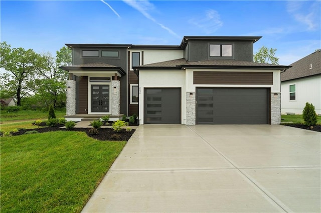 prairie-style home with a garage and a front yard