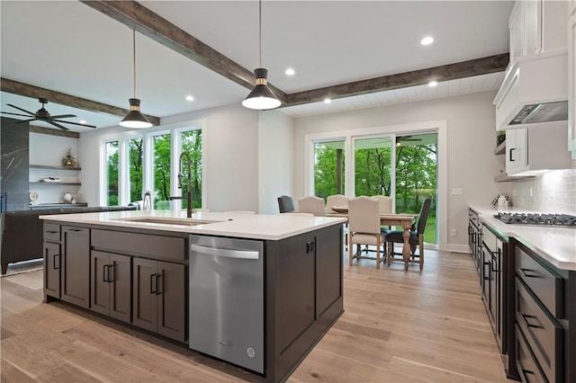 kitchen with white cabinets, beam ceiling, appliances with stainless steel finishes, and hanging light fixtures