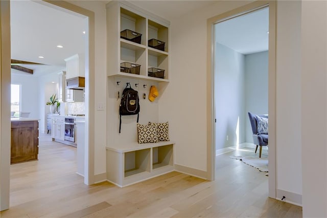 mudroom with light hardwood / wood-style floors