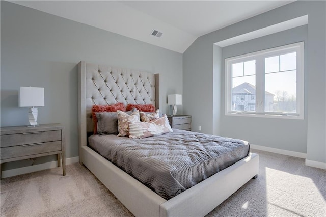 carpeted bedroom with lofted ceiling