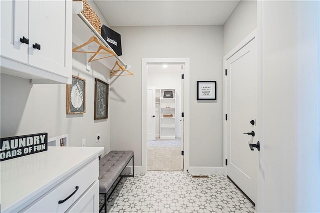 laundry area with cabinets, hookup for an electric dryer, and hookup for a washing machine