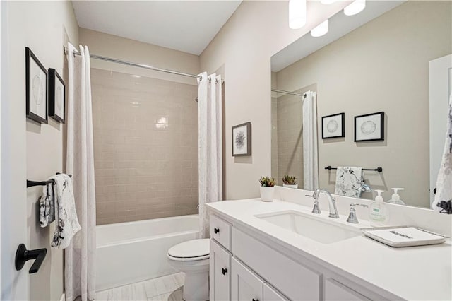 full bathroom with vanity, shower / bath combo with shower curtain, and toilet