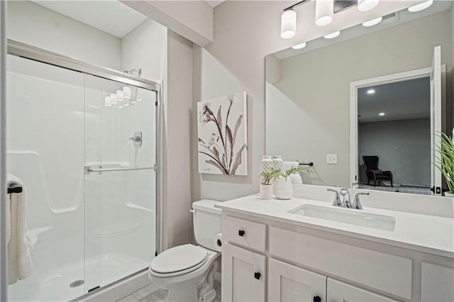 bathroom with vanity, toilet, and an enclosed shower