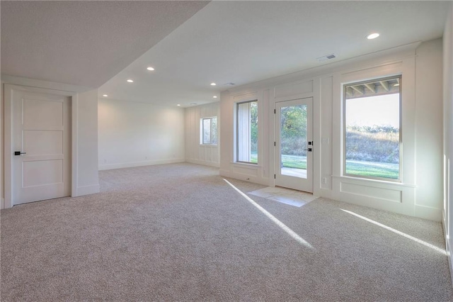 unfurnished living room with light carpet