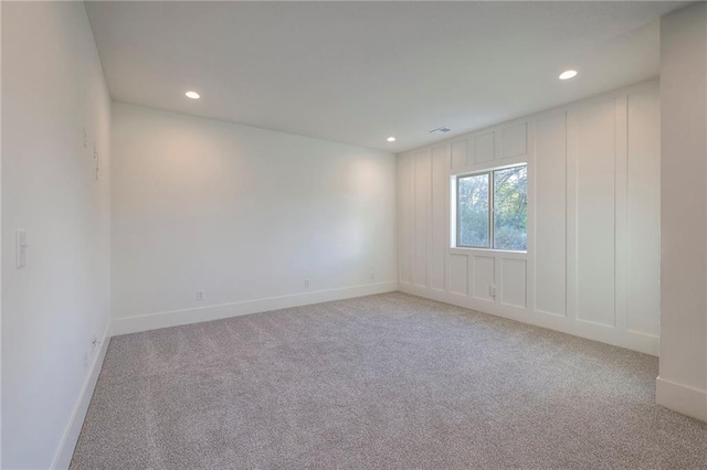 spare room with light colored carpet