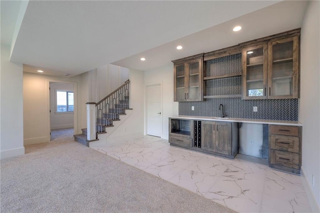 bar with sink and tasteful backsplash