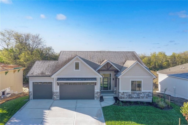 craftsman-style house featuring a front yard and a garage