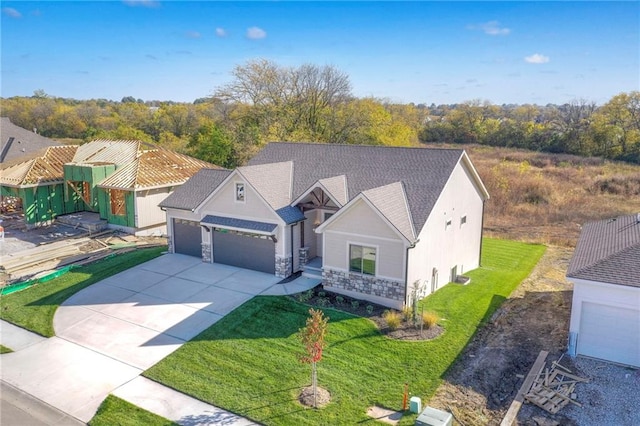 view of front of property featuring a garage and a front lawn