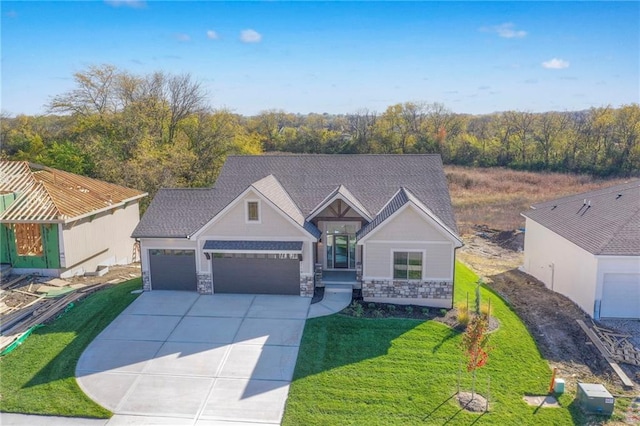 view of front of house with a front yard and a garage