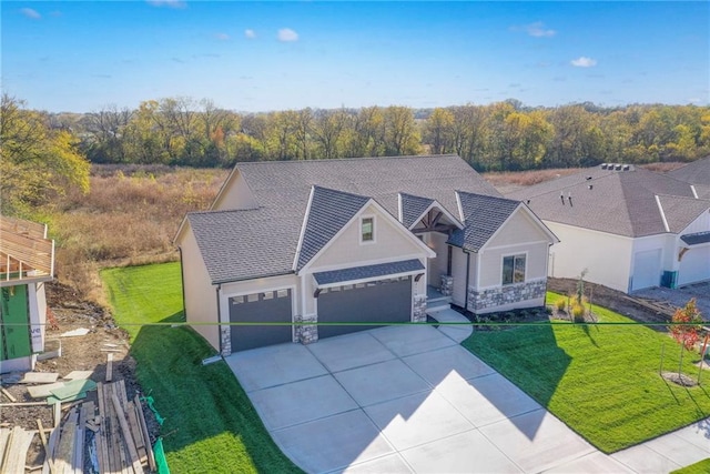 view of front of property featuring a garage and a front lawn