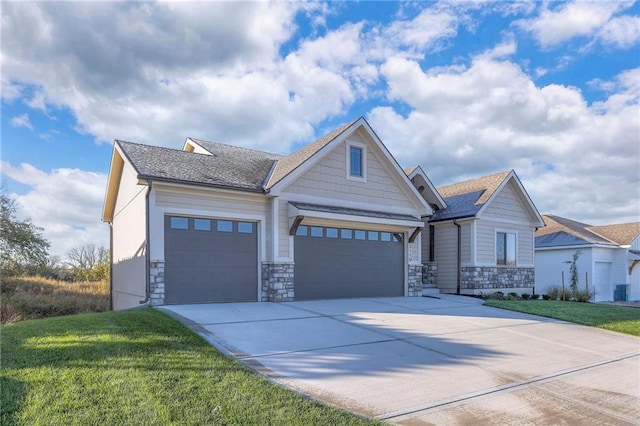 craftsman-style home featuring a garage and a front yard