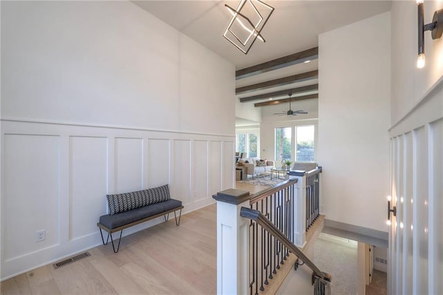 hall featuring light hardwood / wood-style floors and beam ceiling