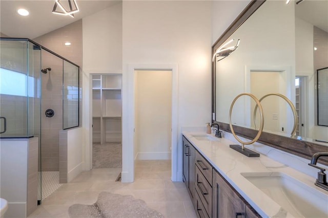 bathroom with tile patterned floors, high vaulted ceiling, a shower with shower door, and vanity