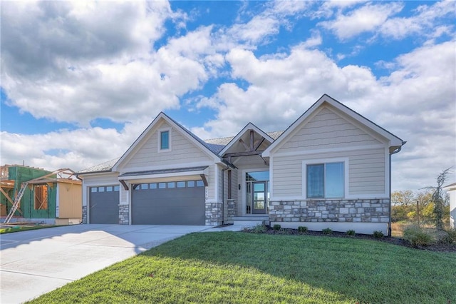 craftsman house with a front yard and a garage