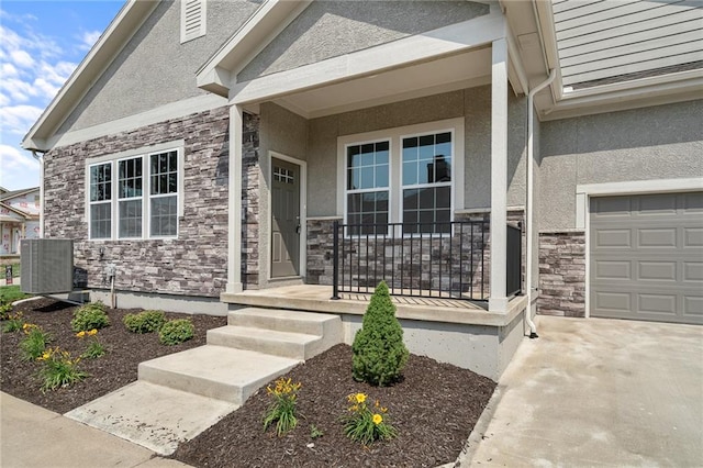 doorway to property featuring a porch and a garage