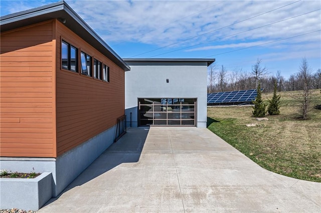 view of side of property featuring a garage and a yard