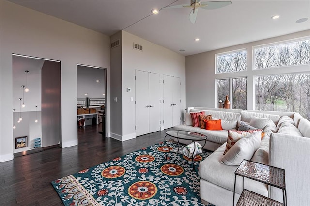 living room with ceiling fan and dark hardwood / wood-style floors