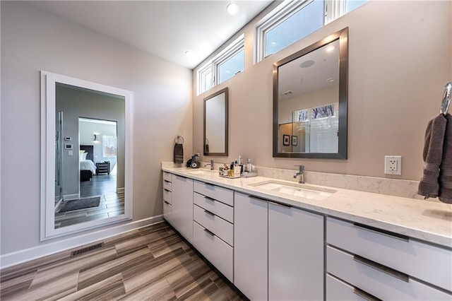 bathroom with large vanity and dual sinks