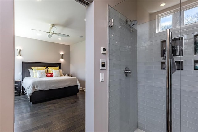 interior space featuring ceiling fan, tiled shower, and wood-type flooring