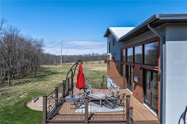 wooden terrace featuring a lawn