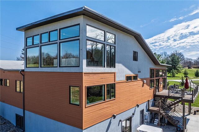 view of side of property with a wooden deck