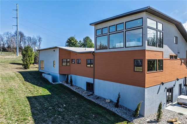 view of side of property with a lawn