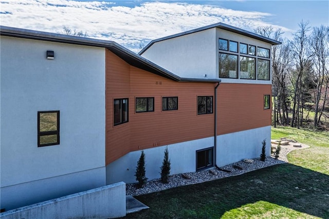 view of side of home with a lawn