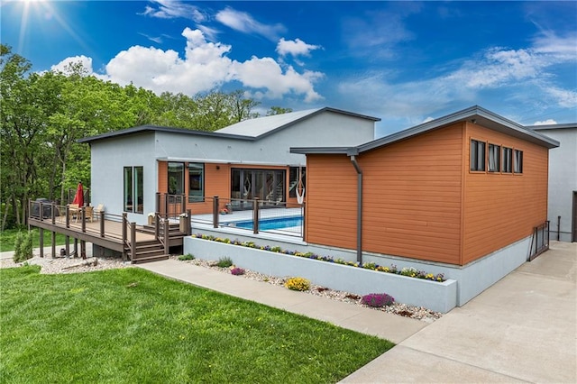 contemporary home with a swimming pool side deck and a front lawn